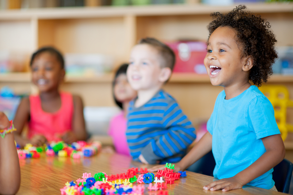 Kindergarten children playing with toys.