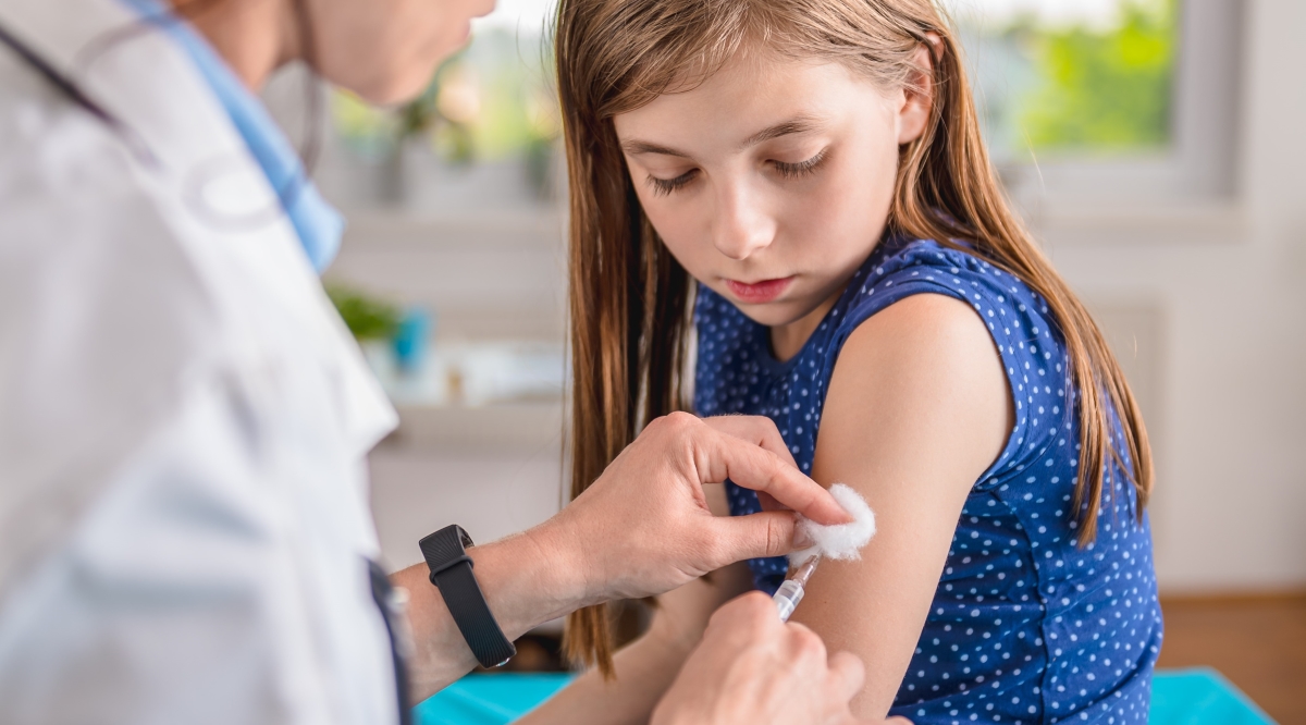 Young girl receiving vaccination from provider