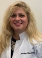 Jennifer Chevinsky poses in her white coat. 