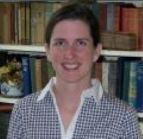 Kristen Oliver smiles with a collared top. 