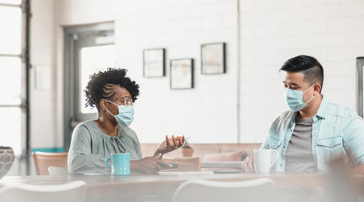 A woman and a man wearing protective masks during COVID-19.