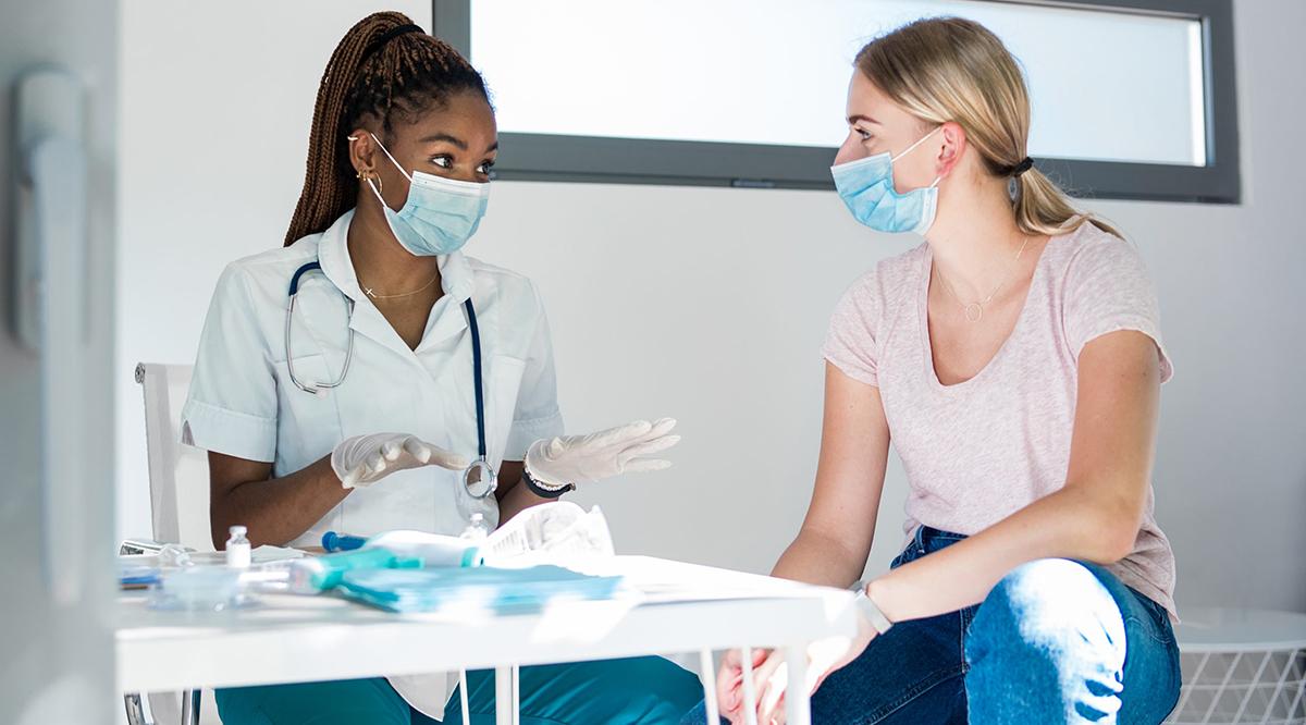 A nurse explaining the vaccine to a patient