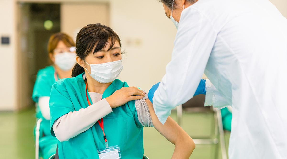 A group of frontline healthcare workers are getting vaccinated in a vaccination center.