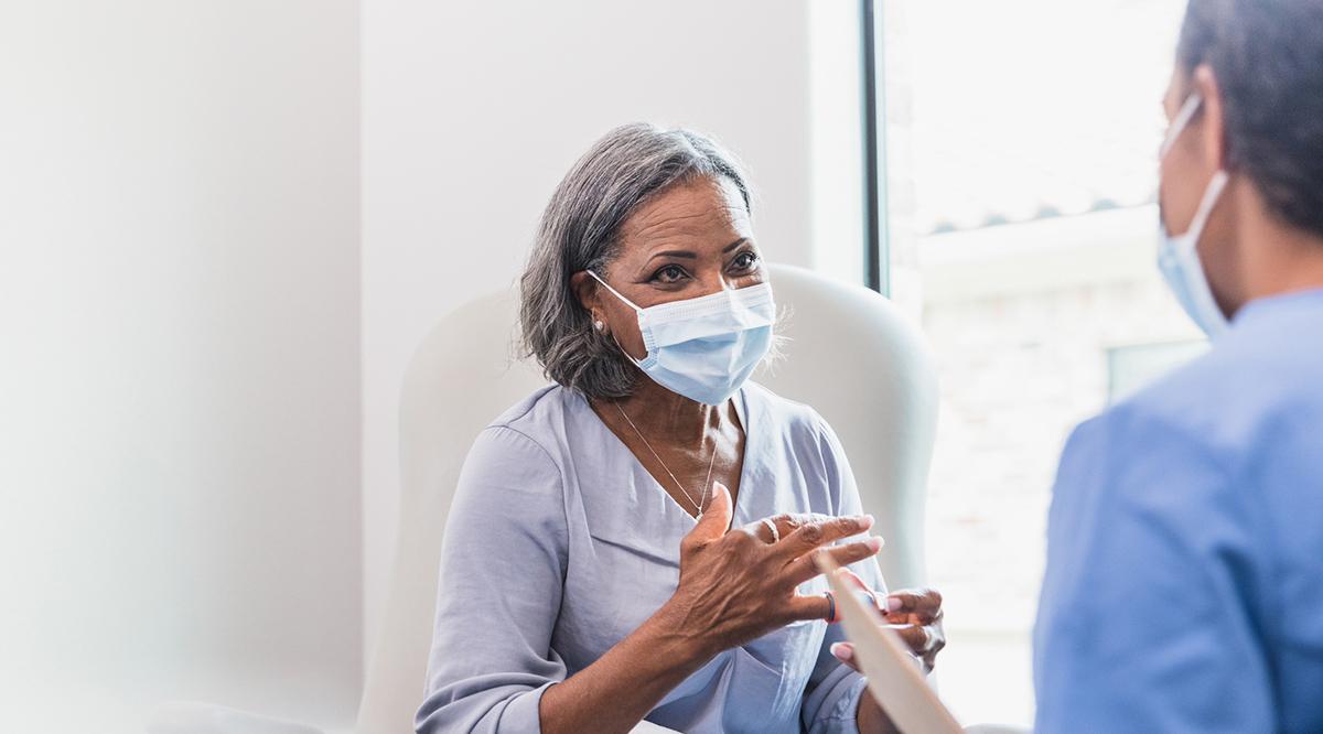 Senior adult patient talks with doctor