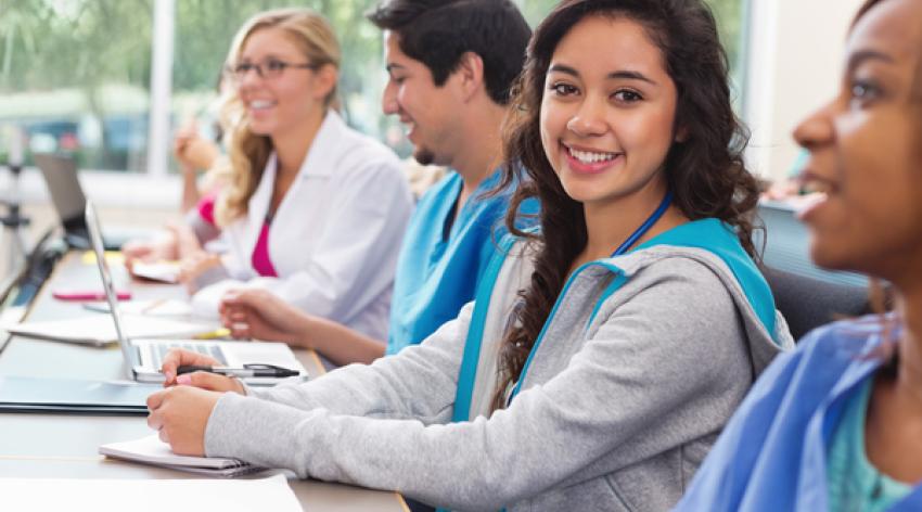 Pretty student smiling in nursing or medical school college class.