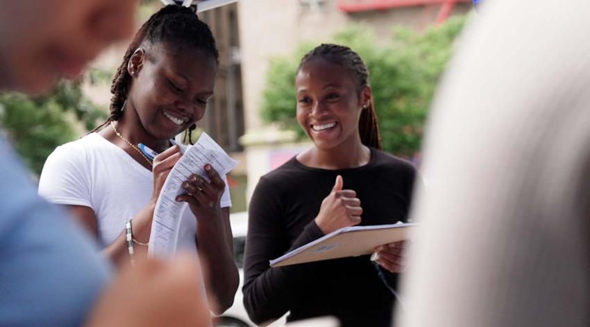 Two young women attend the CARE Hub event hosted by Albert Einstein in the Bronx, NY which offered health screenings, giveaways, and activities for children.