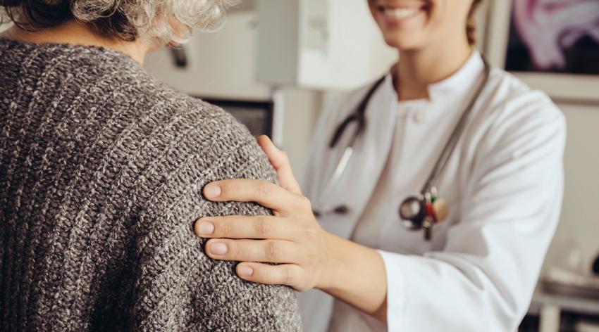 Doctor soothing senior patient